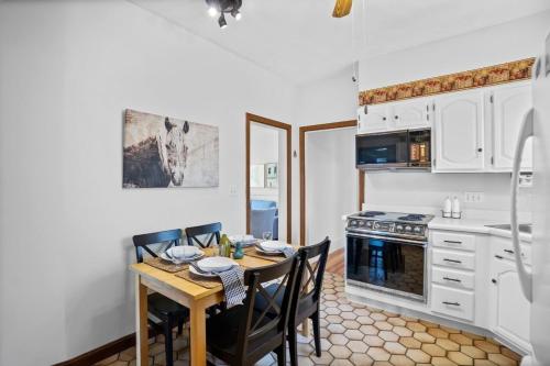 a kitchen with a wooden table with chairs and a stove at Charming New England style apartment 6 miles to downtown Boston, 4 miles to Logan airport in Revere