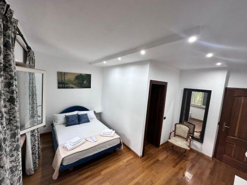 a bedroom with a bed and a chair in it at Villa Garden in Sabaudia
