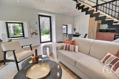 a living room with a couch and a table at Rubis in Troguéry