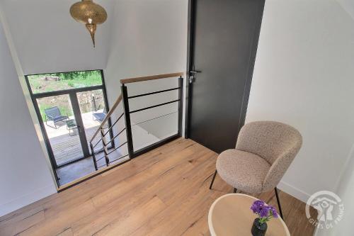 a room with two chairs and a table and a door at Rubis in Troguéry