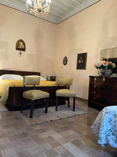 a bedroom with a bed and a table and chairs at Villa Ada in Monsummano