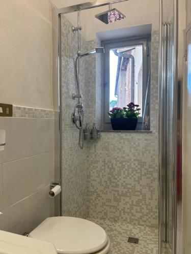 a bathroom with a toilet and a window at Villa Ada in Monsummano