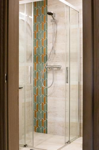 a shower with a glass door in a bathroom at Rossak apartment 2 in Panevėžys