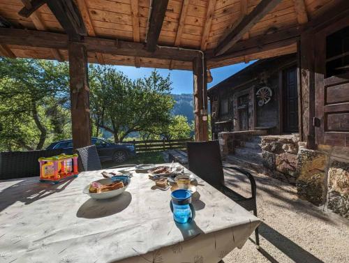 a picnic table on the patio of a house at Kojadinovica Koliba in Mokra Gora