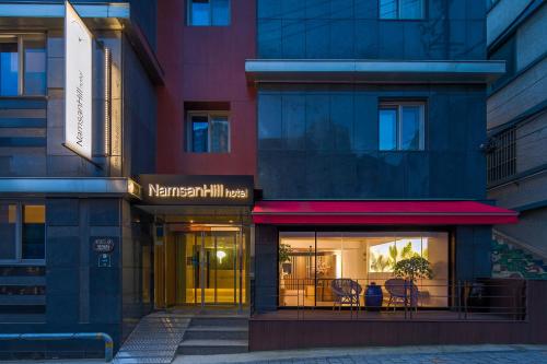 a store front with tables and chairs in a building at Namsan Hill Hotel in Seoul