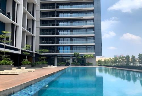an image of an apartment building with a swimming pool at Cozy Vertu Ciputra World Studio Apartment in Surabaya by Le Ciel Hospitality in Surabaya