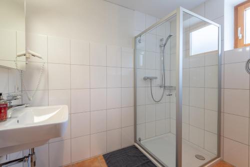 a bathroom with a shower and a sink at Haus Emilia am Faschinajoch in Fontanella