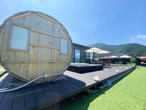 a round house on a deck with a house at Seaside Garden Nishiizu 2 in Nishiizu