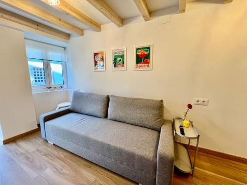 a living room with a couch and a table at A Casiña do Rey Casita junto a la playa de Cabañas in Cabañas