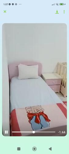 a bedroom with a bed with a white bedspread at Villa raif in Djerba
