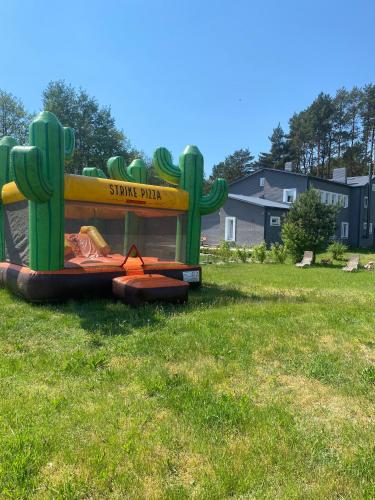 a small playground in a field with a play structure at Guest House Saulgriezes in Nīca