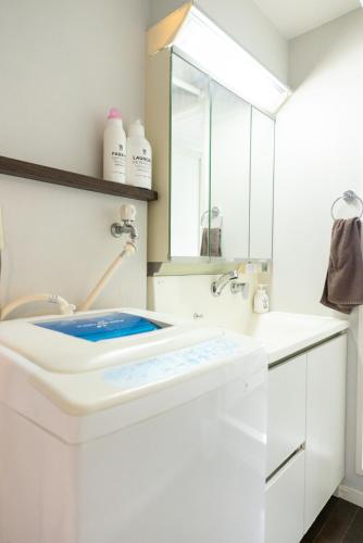 a bathroom with a sink and a mirror at Yakuin apartment in Fukuoka