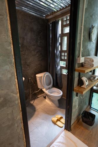 a bathroom with a toilet and a sink at Bee Forest in Ban Pok Nai