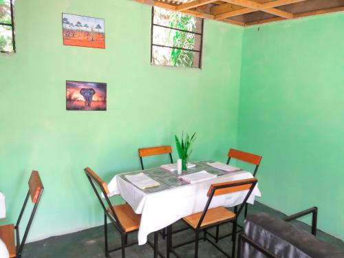 a dining room with a table and chairs at Ngorongoro Villa and Restaurant in Karatu