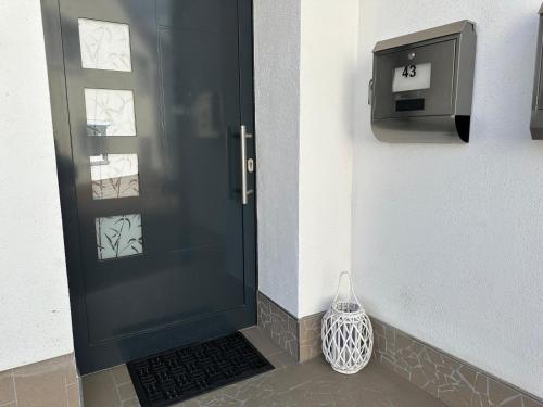 a black door with a vase next to a box at Wohnung in Mülheim-Kärlich in Mülheim-Kärlich