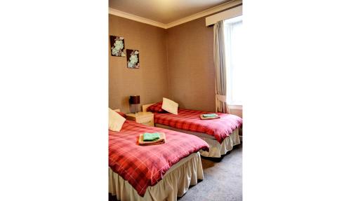 Postel nebo postele na pokoji v ubytování Atticus Central Guest House