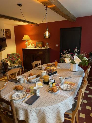 a table with food on it in a living room at La Chaise Haute in Hagetmau