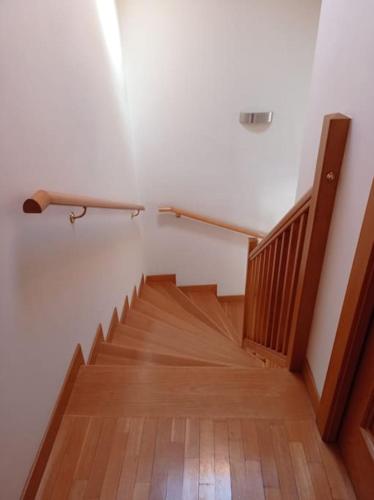 a hallway with a staircase with a wooden floor at Residenza Al Capitello in Ceniga