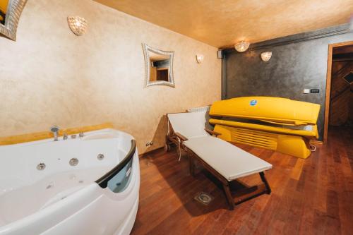 a bathroom with a tub and a yellow suitcase at NEW!!! La Magrina - Bed&Breakfast in Vrsar