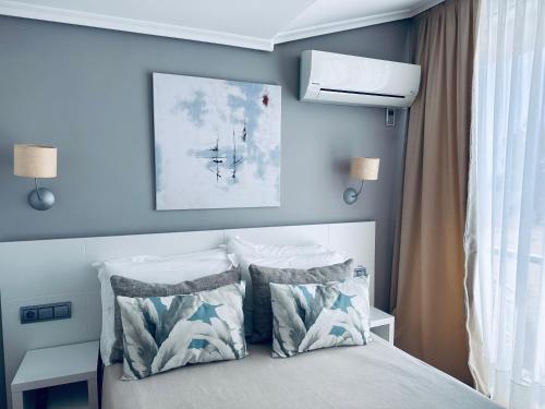 a bedroom with a bed with two pillows at Hotel Las Olas in Noja