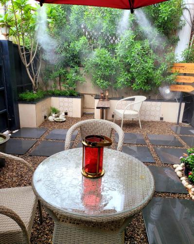a table with a candle on it on a patio at Victorian Elegance Luxury Stays in Amritsar