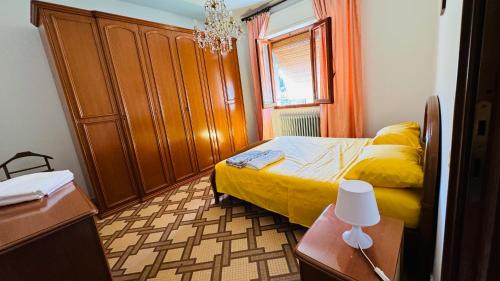 a bedroom with a bed and a wooden cabinet at Casa Odry in Massa