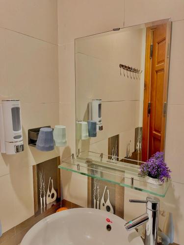 a bathroom with a sink and a large mirror at Lynk Stay Hoian in Hoi An