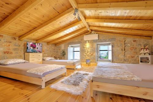 a bedroom with two beds and a wooden ceiling at Crown House in Areopolis in Areopoli