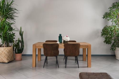 a dining room table with chairs and plants at Hotel Admiral Lugano in Lugano