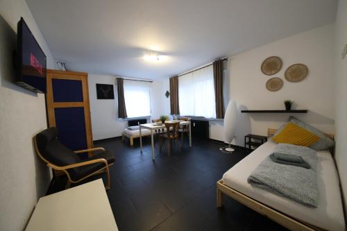 a room with a bed and a desk and a table at NEW Luxury Apartment in Heilbronn Neckarsulm in Heilbronn
