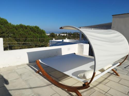 a chair sitting on top of a roof at RIZZO RELAX Residence SALENTO in Capilungo