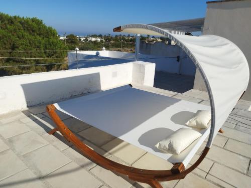 a chair on the roof of a house at RIZZO RELAX Residence SALENTO in Capilungo