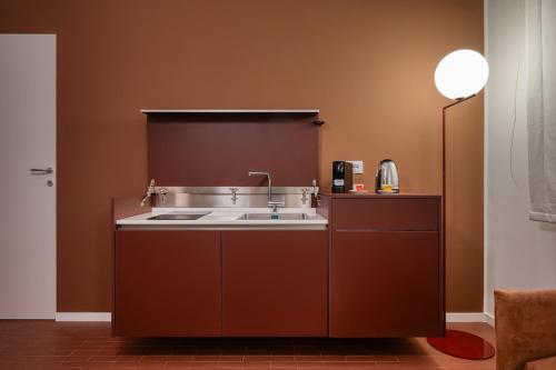 a kitchen with a sink and a lamp at Via Fiasella - Le Case di Bart in Genoa