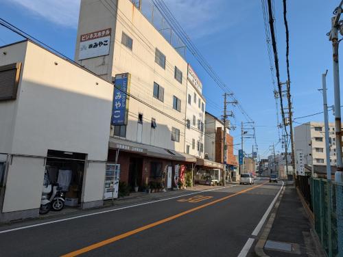 an empty street in a city with buildings at ビジネスホテルみやこ in Higashi-osaka