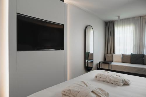 a hotel room with a bed and a flat screen tv at Hotel Admiral Lugano in Lugano