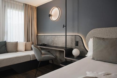 a hotel room with a bed and a desk at Hotel Admiral Lugano in Lugano