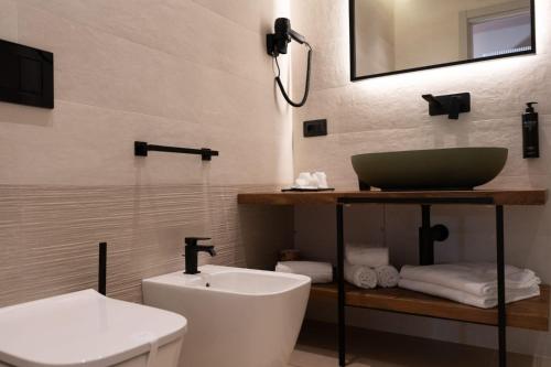 a bathroom with a sink and a toilet at ananea Tropea Yachting Resort in Tropea
