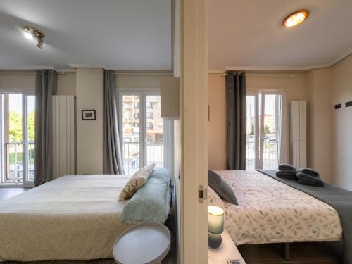 ein Schlafzimmer mit großem Bett und Balkon in der Unterkunft Forum Evolucion Residence in Burgos