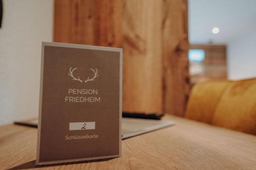 a sign sitting on top of a table at Frühstückspension Friedheim in Filzmoos