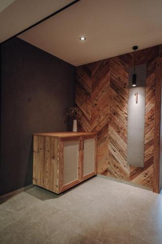 a room with a wooden wall with a wooden cabinet at Frühstückspension Friedheim in Filzmoos