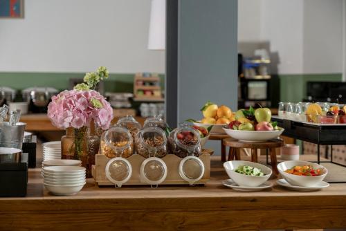 a table with plates and bowls of food on it at Hotel Admiral Lugano in Lugano