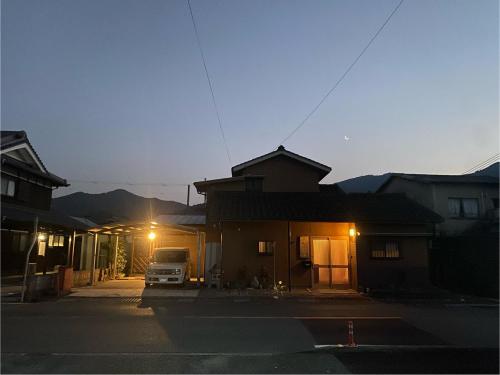 a truck parked in front of a house at night at GUESTHOUSE mame庵 in Tamba