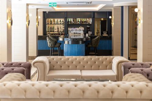 a lobby with a couch and a bar at Delta Hotels by Marriott Antalya Lara - Adult Only 18 Plus in Antalya