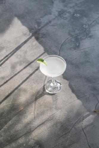 a martini glass with a lime on the ground at Matala Bay Hotel in Matala