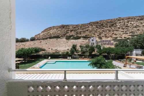 a view of a swimming pool from the balcony of a building at Matala Bay Hotel in Matala