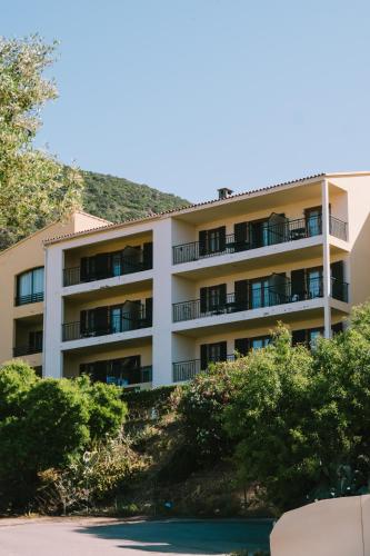 an apartment building with a hill in the background at Creste E Mare in Ajaccio