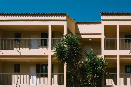a building with two palm trees in front of it at Creste E Mare in Ajaccio