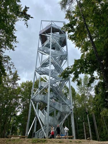 a metal tower with people standing in front of it at Chalet Durik Bystra - Jacuzzi - Sauna - In the forest - 10 min walk to restaurant - On hiking trail in Horná Lehota