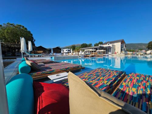 a swimming pool with two mats on the top of it at Ioannina Camping- Glamping in Neo Mpizani