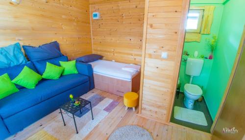 a living room with a blue couch and a toilet at Retro Pool House in Mostar